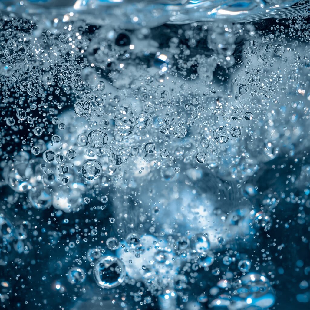 lucid-origin_Bubbling_effervescent_water_in_a_glass_shimmering_with_a_dazzling_array_of_spark-0
